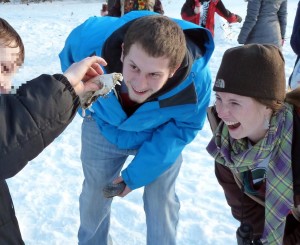 A Sherman Middle school student shows off a raccoon jaw he found in the dog park to his UW mentors.