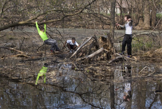 Sherman Middle School students Colin Knauer, left, 11, 6th grade, Armon Vaccaro, 12, 6th grade, and Marcos Davis, 14, 8th grade, explore Warner Park last week during a nature outing. (Photo by Andy Manis)